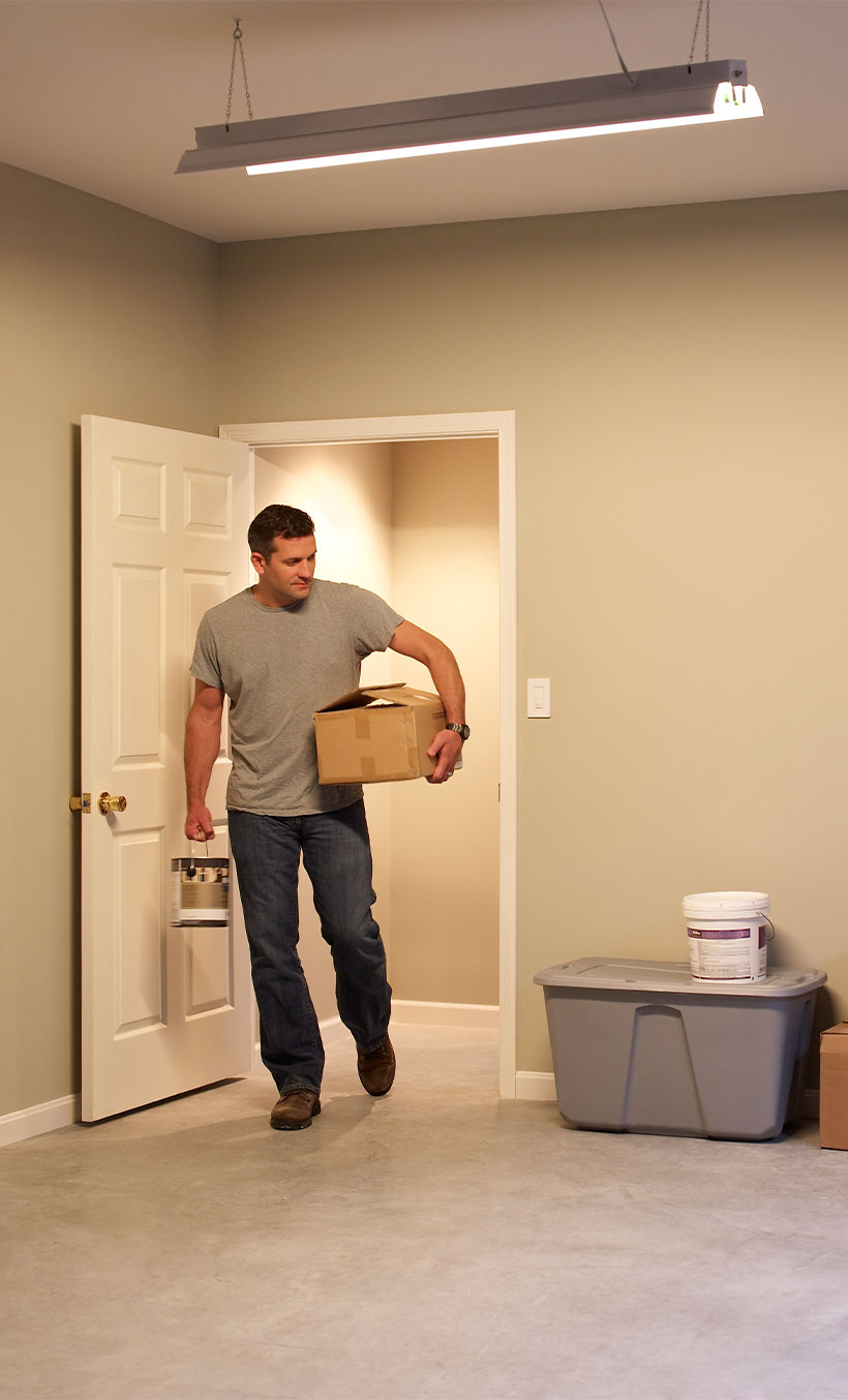 Woman walking out of bathroom, leaving lights dimmed. 