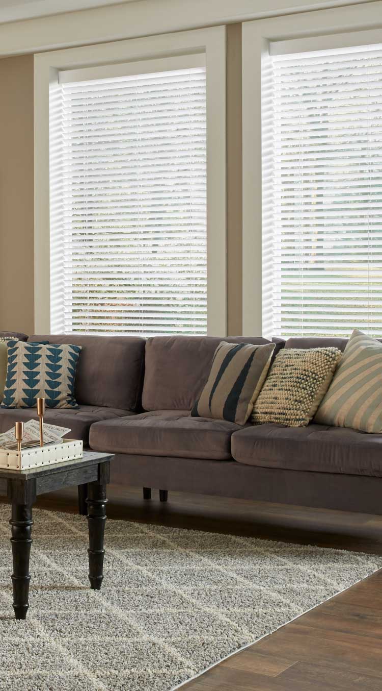 Living room with Serena wood blinds showcasing blinds tilted based on the sun's position