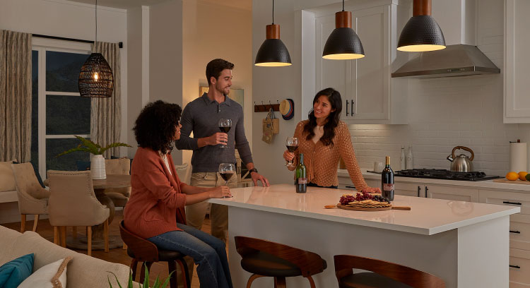 Entertaining friends in open concept kitchen with dimmed lights