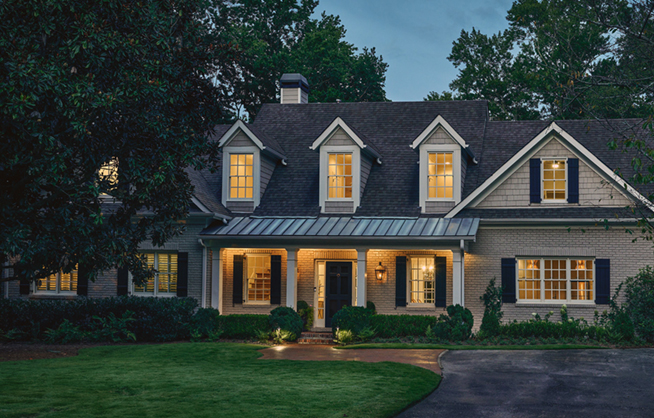 Exterior of home at dusk with lights on inside