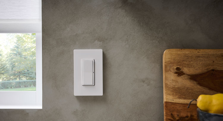 Pico Paddle remote mounted to wall above kitchen counter with cutting board and fruit bowl